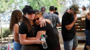 A woman comforts a mourner at a memorial ceremony for the community of Kibbutz Kfar Aza, on the third anniversary of the Hamas-led attack on Israel on 7 October 2023, in Kfar Aza, southern Israel (7 October 2026)