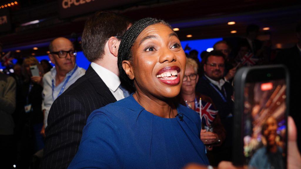 Kemi Badenoch grins at supporters after leaving the stage at the Conservative Party conference