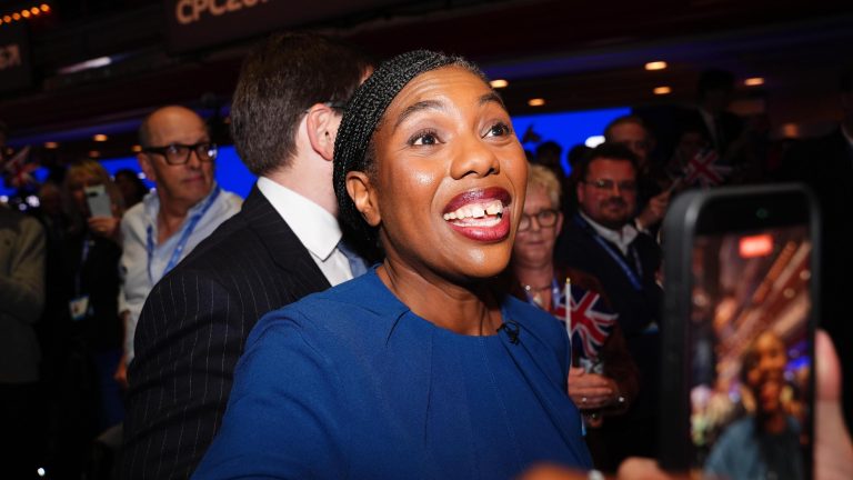 Kemi Badenoch grins at supporters after leaving the stage at the Conservative Party conference