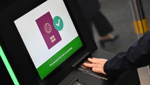 A passenger scanning their passport at an egate