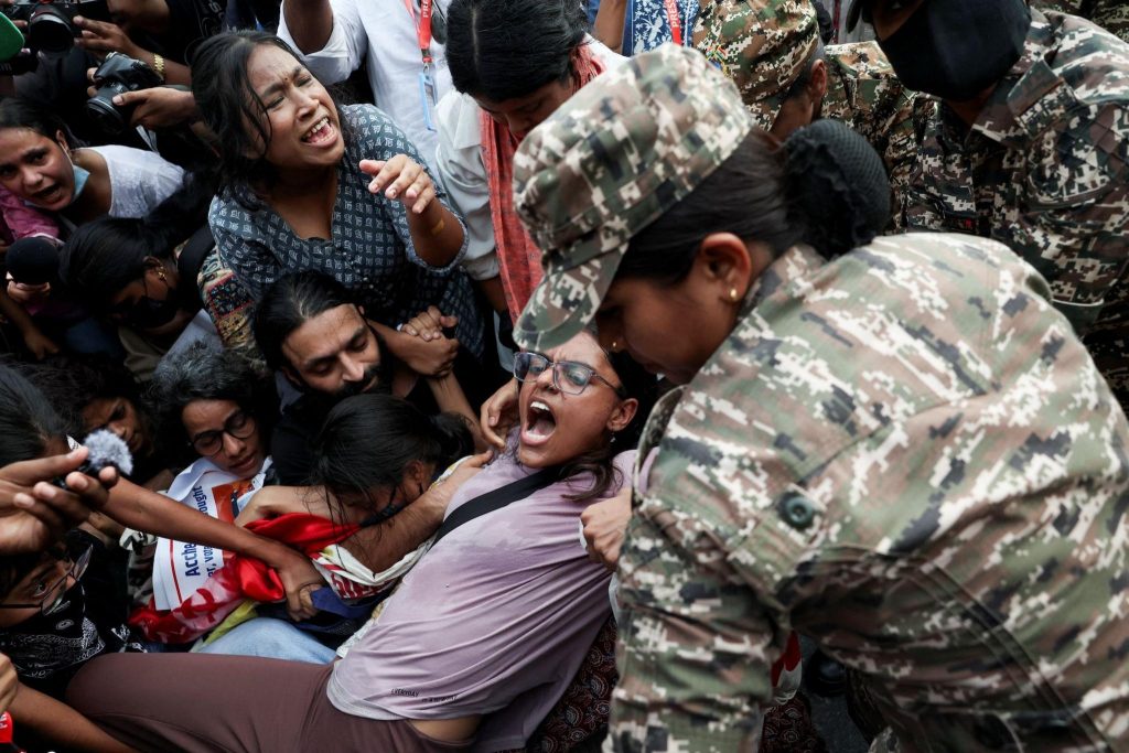 Protesters react as they are detained by security personnel during a protest seeking the resignation of India's Chief Election Commissioner Gyanesh Kumar, in New Delhi, India, October 11, 2026.